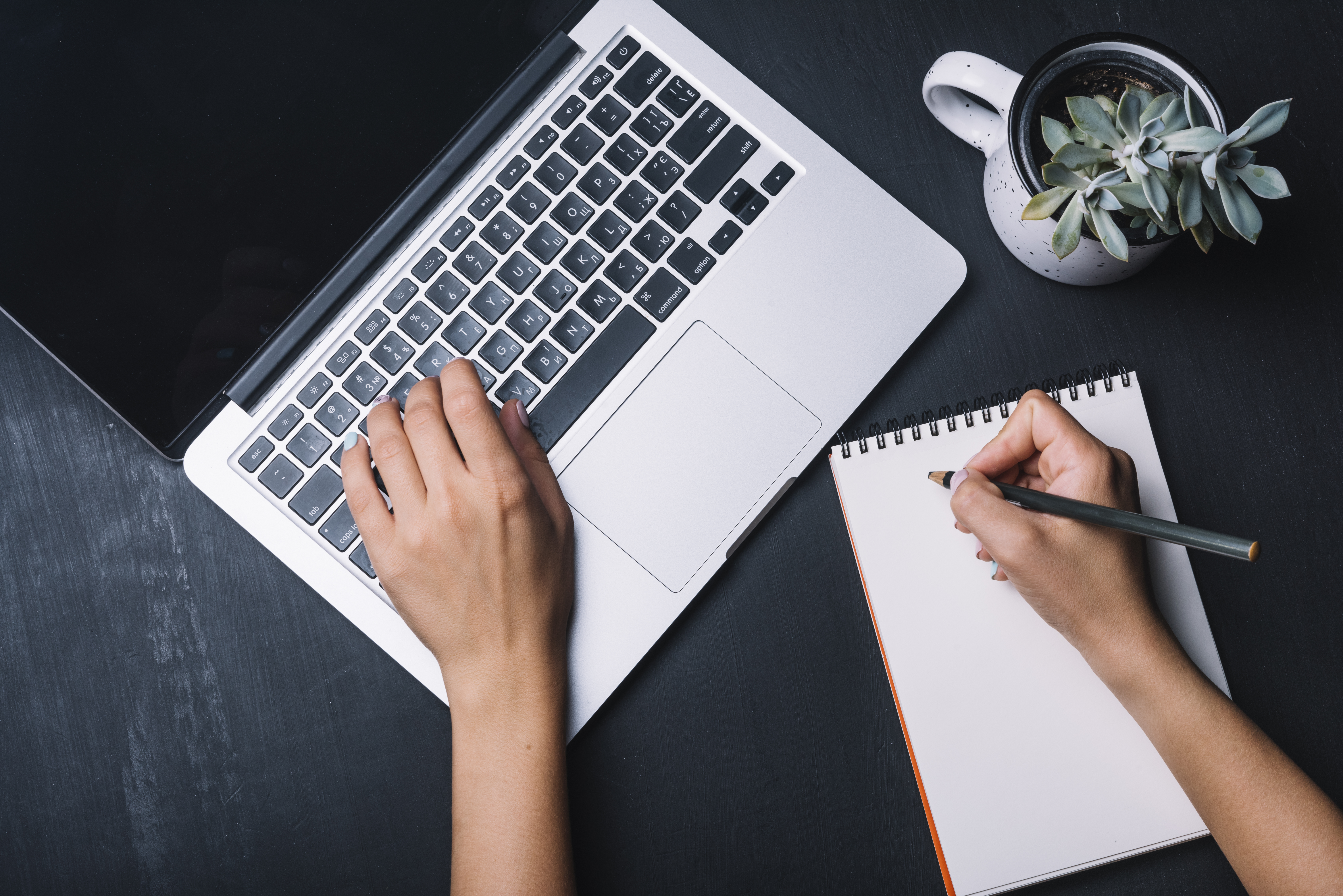 A guide to better email writing. Photo of open laptop and writing pad. 