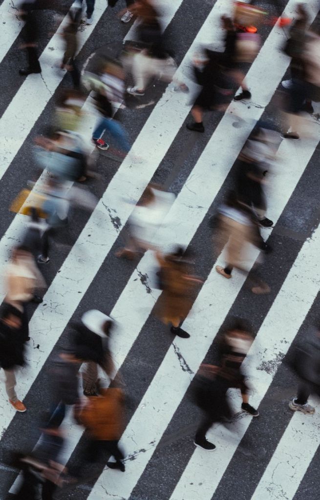 People crossing a street in a city