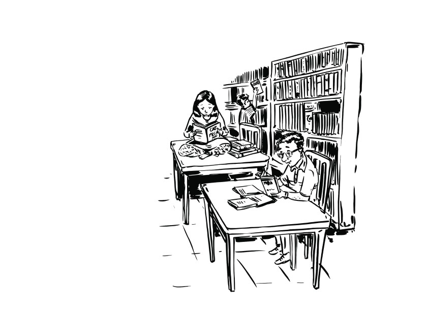 Two students reading at a library